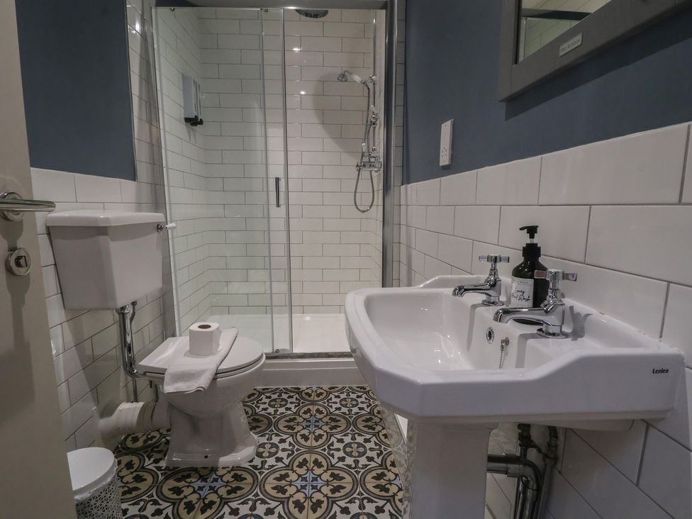 A bathroom with a shower and sink at Ravenswood Penthouse in Chester