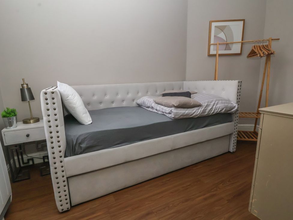 A daybed with pillows and a nightstand at Ravenswood Penthouse in Chester