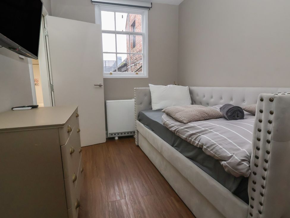 A bedroom with a bed and dresser at Ravenswood Penthouse in Chester