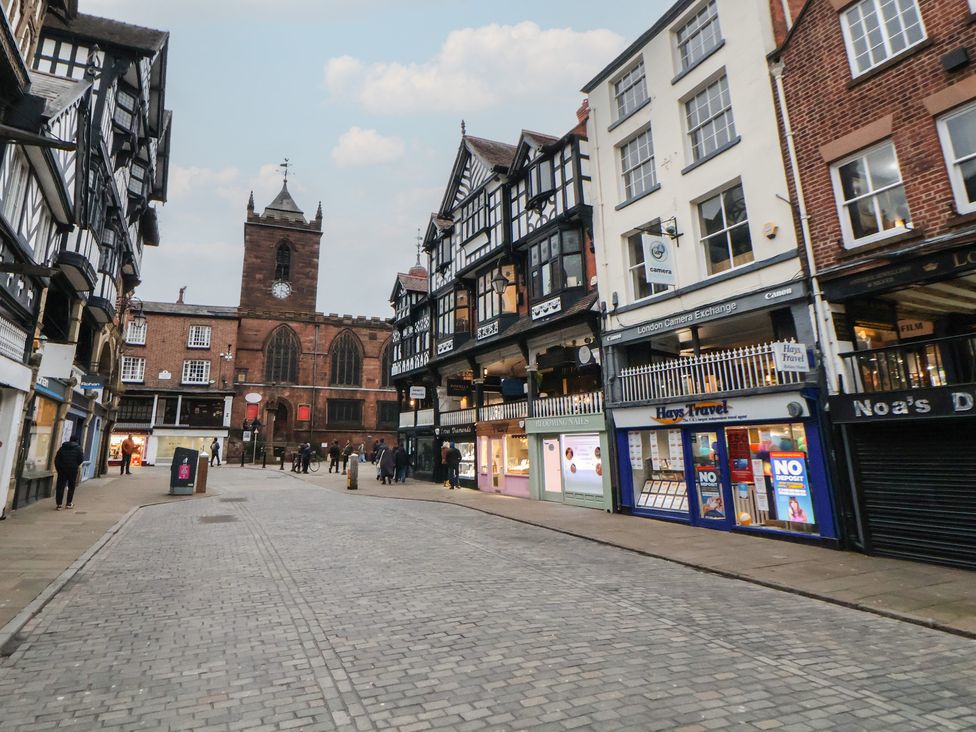 A street with shops and a clock tower at Ravenswood Penthouse in Chester