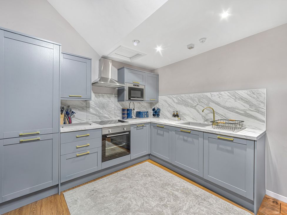 A kitchen with cabinets and appliances at Kingsley Loft in Chester