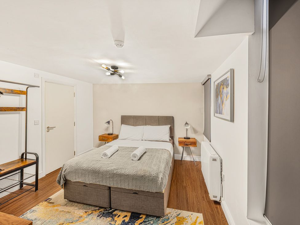 A bedroom with a bed and nightstand at Kingsley Loft in Chester