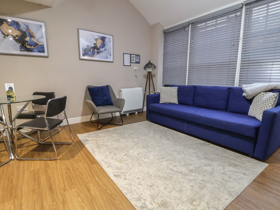 A living room with a sofa and table at Kingsley Loft in Chester