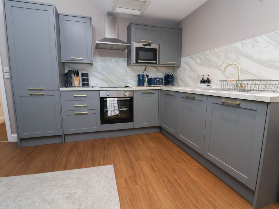A kitchen with gray cabinets and appliances at Kingsley Loft in Chester