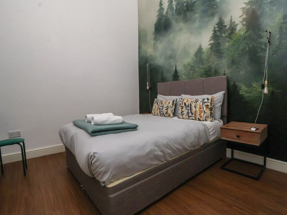 A bedroom with a bed and bedside table at Kingsley Loft Chester