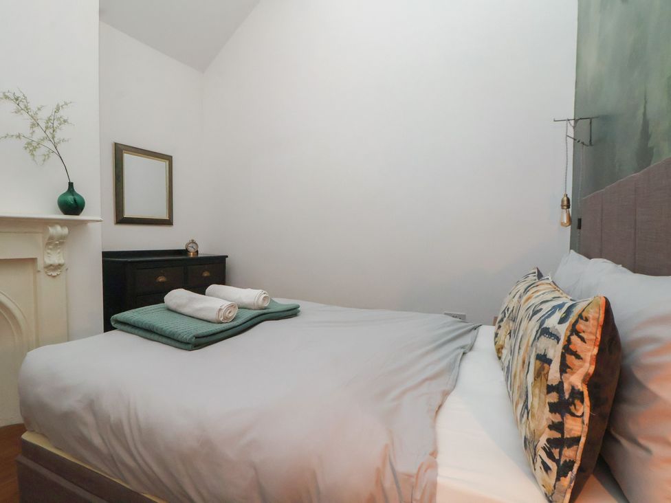 A bedroom with a bed and decorative items at Kingsley Loft Chester