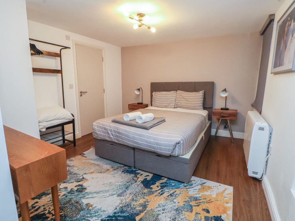 A bedroom with a bed and nightstands at Kingsley Loft Chester