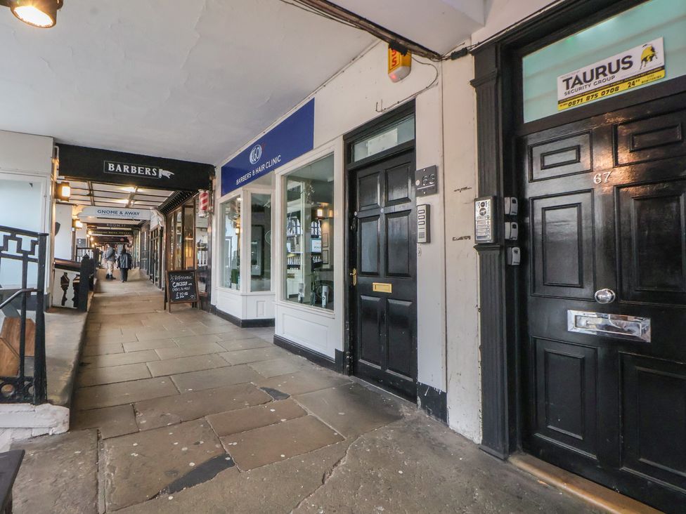 An outdoor area with shops including a barber and hair clinic at Kingsley Loft, Chester