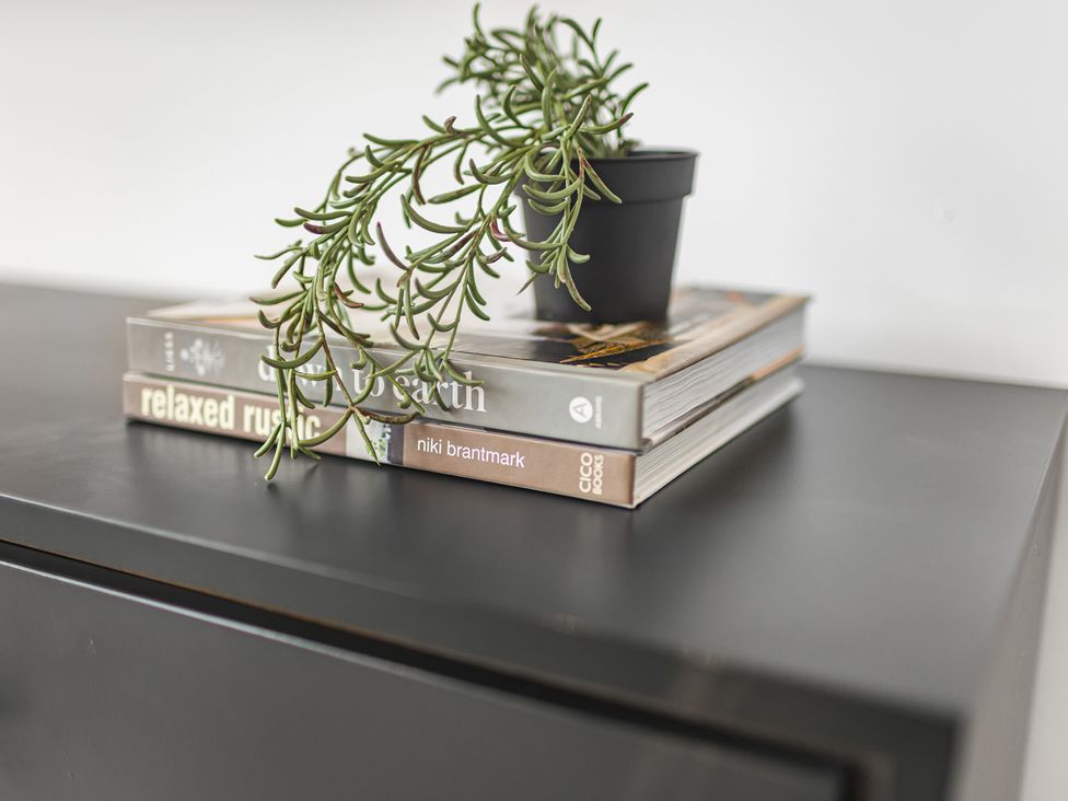 A stack of books with a plant on top at Southview Apartment in Chester