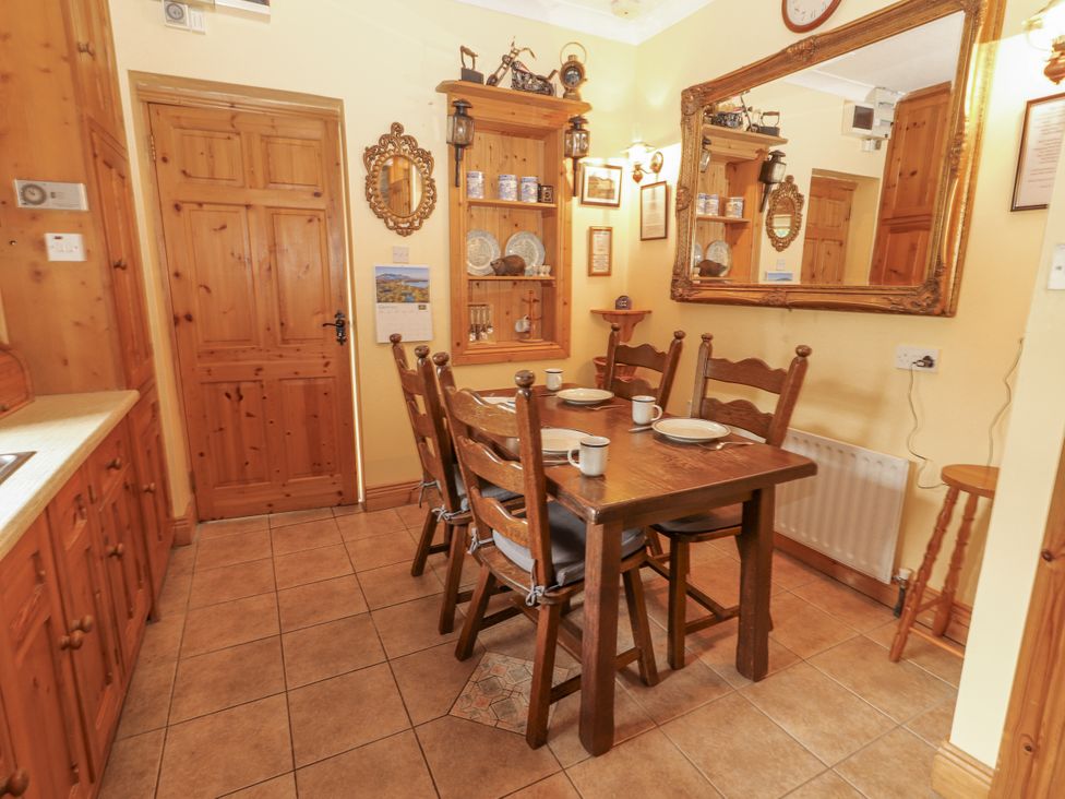 A dining room with a table and chairs at Coole Gate Lodge, Gort, County Galway