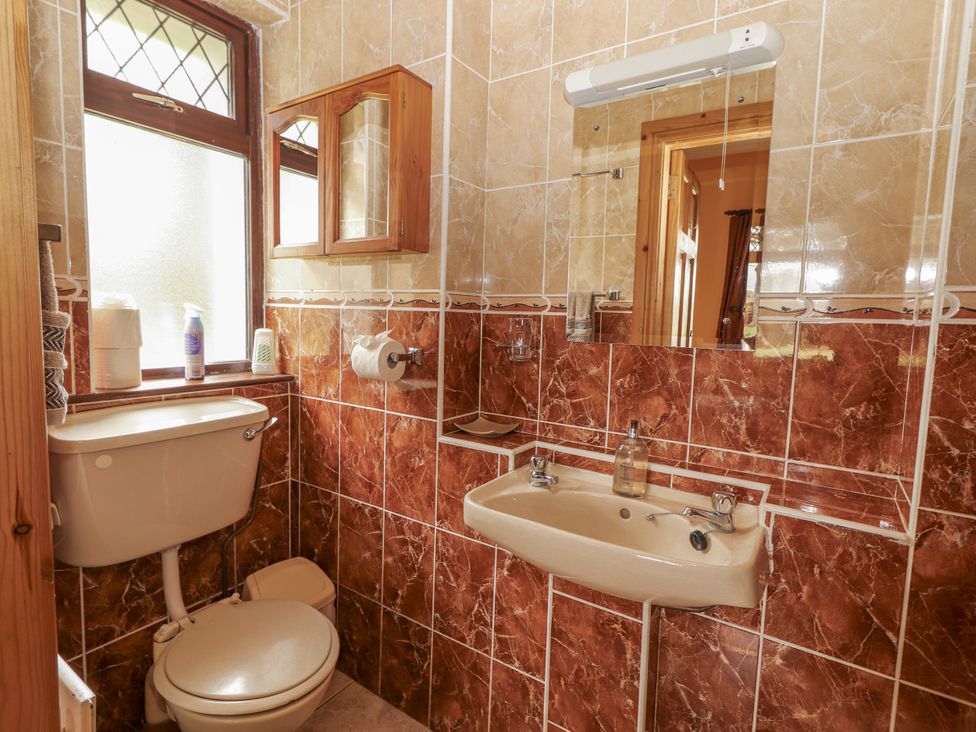 A bathroom with a toilet and sink at Coole Gate Lodge, Gort, County Galway