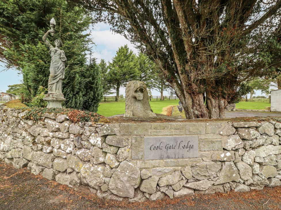 A statue and stone wall at Coole Gate Lodge in Gort, County Galway