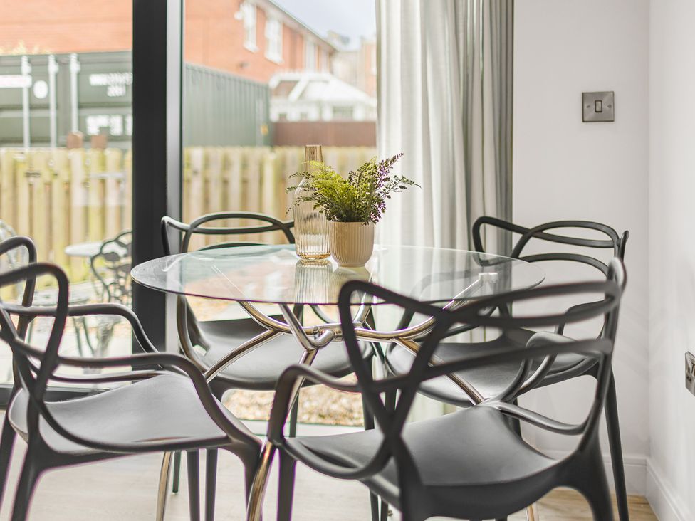 A dining room with a round table and chairs at Eastgate Suite in Chester