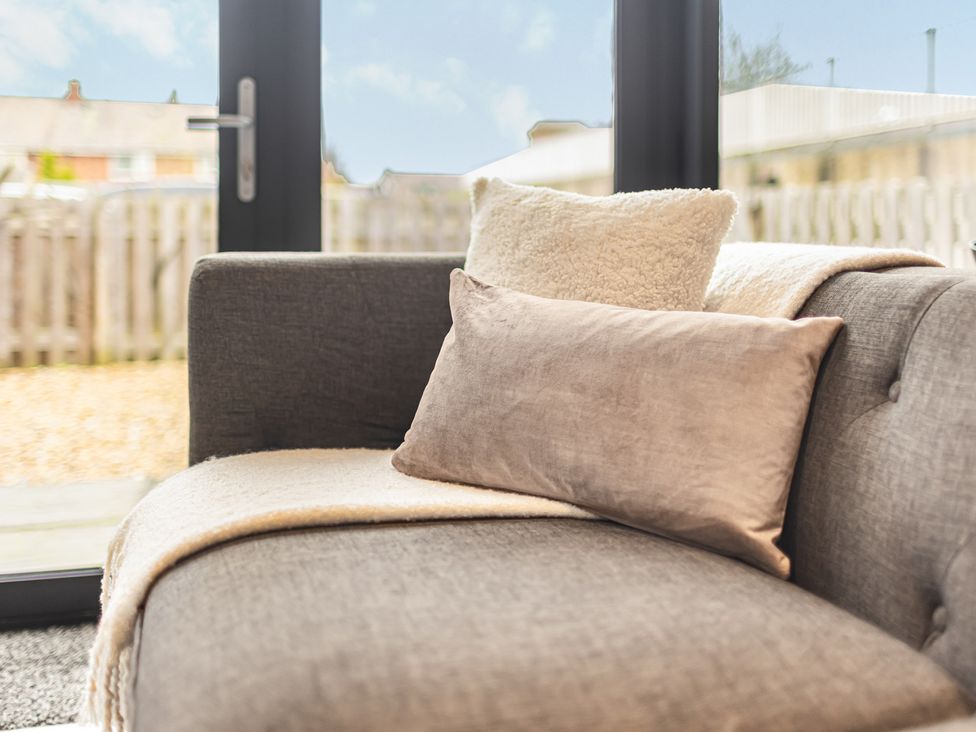 A sofa with cushions and a throw blanket at Newland Suite in Chester