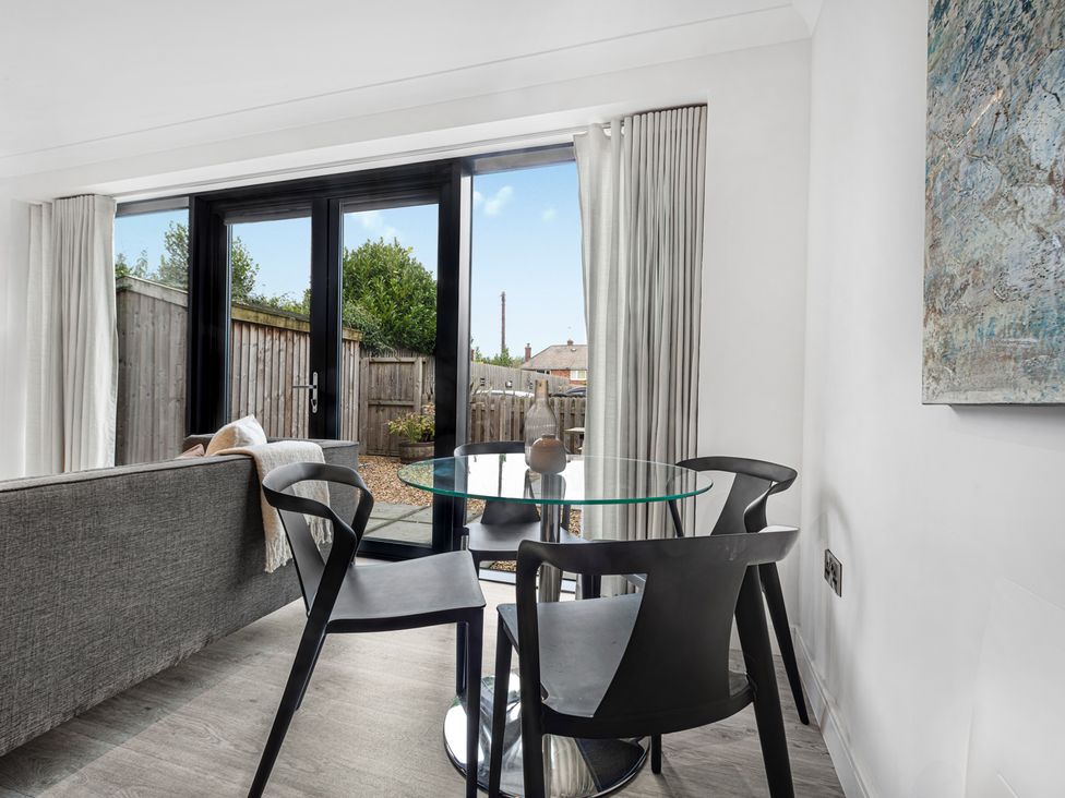 A dining room with a table and chairs at Newland Suite in Chester
