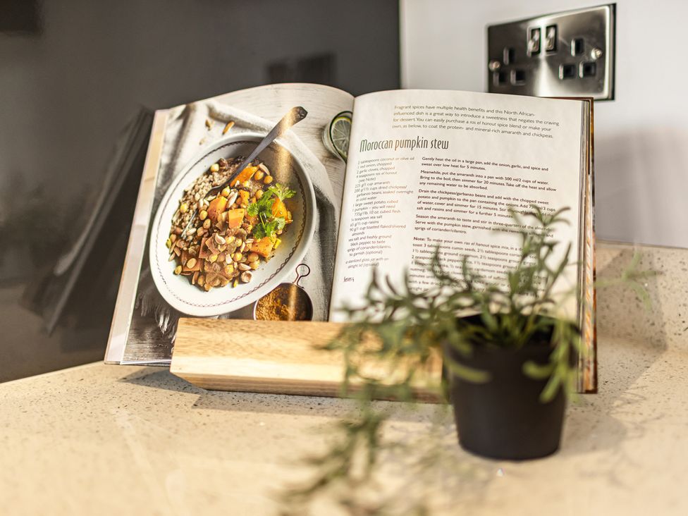 A cookbook opened to a recipe on a kitchen countertop at Newland Suite Chester