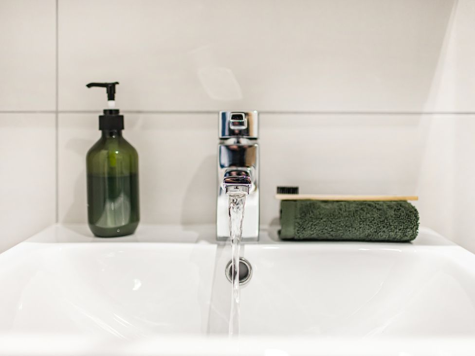 A sink with a tap and soap dispenser at Newland Suite in Chester