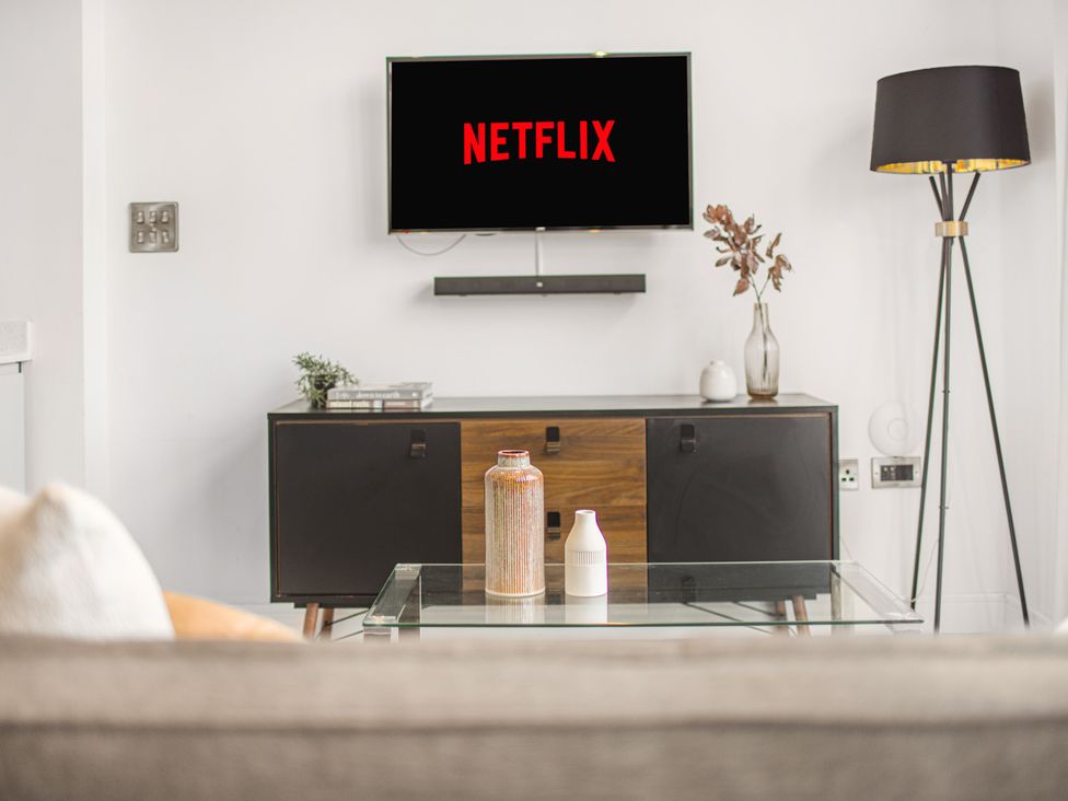 A living room with a television and coffee table at Mulberry Apartment in Chester