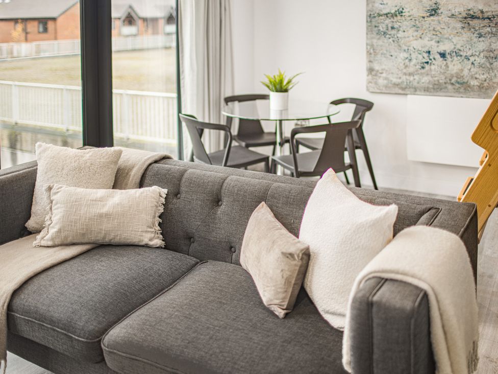 A living room with a sofa and table at Mulberry Apartment in Chester