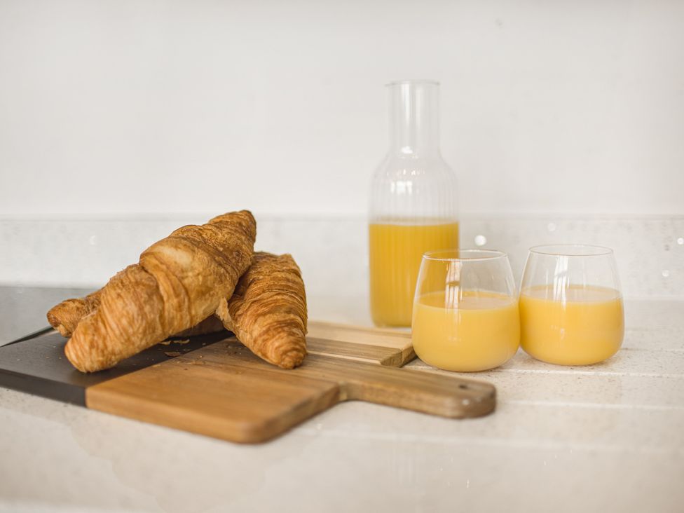 A kitchen counter with croissants and juice at Mulberry Apartment in Chester