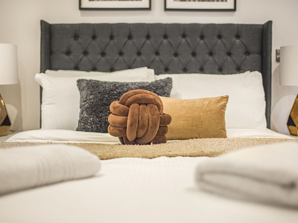 A bedroom with a bed and decorative pillows at Mulberry Apartment in Chester