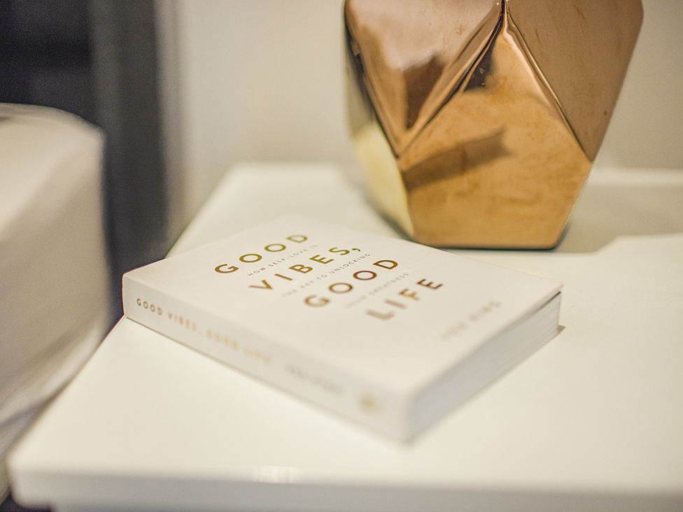 A book and a decorative vase on a surface at Mulberry Apartment, Chester