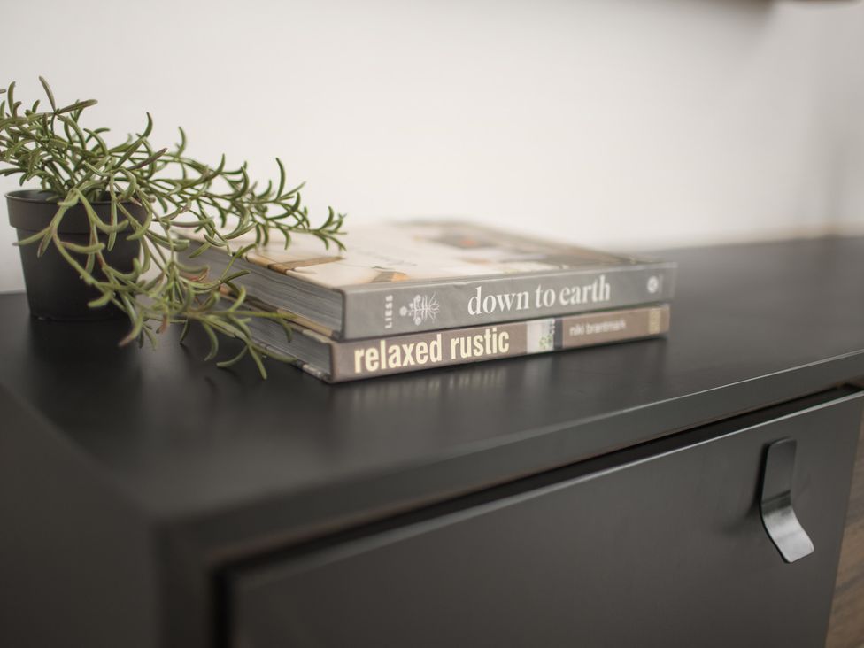 A table with a potted plant and books at Mulberry Apartment in Chester