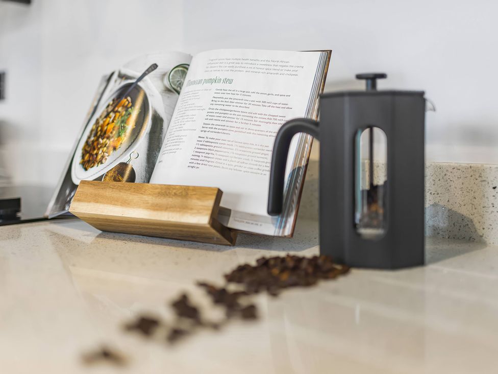 A kitchen with a cookbook and coffee maker at Grosvenor Apartment in Chester