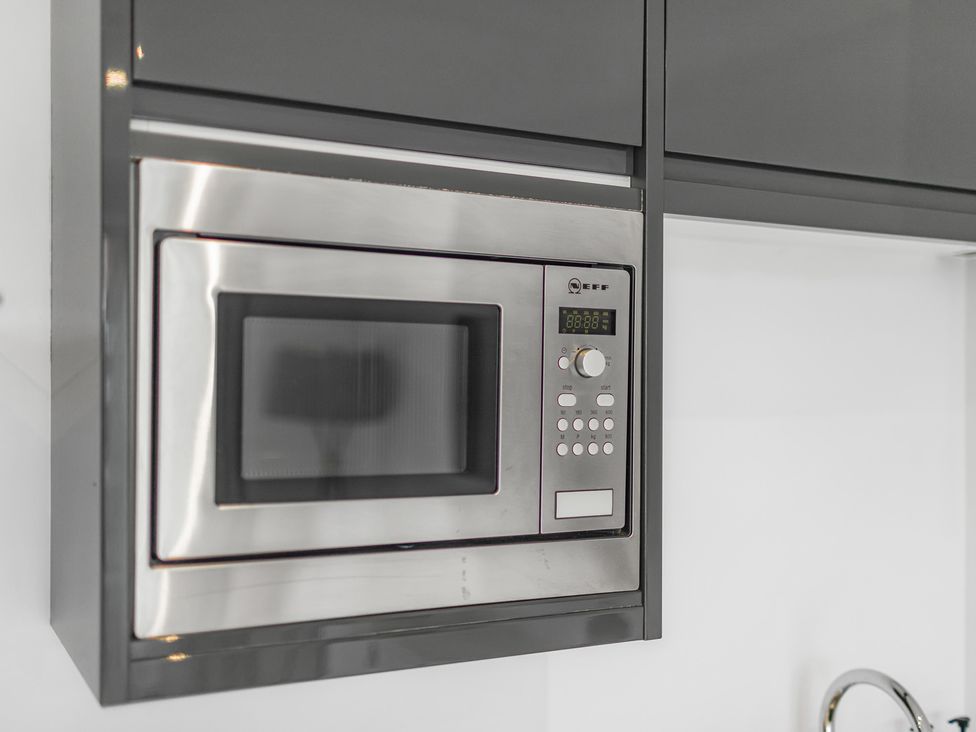 A microwave mounted in cabinetry at York Suite in Chester