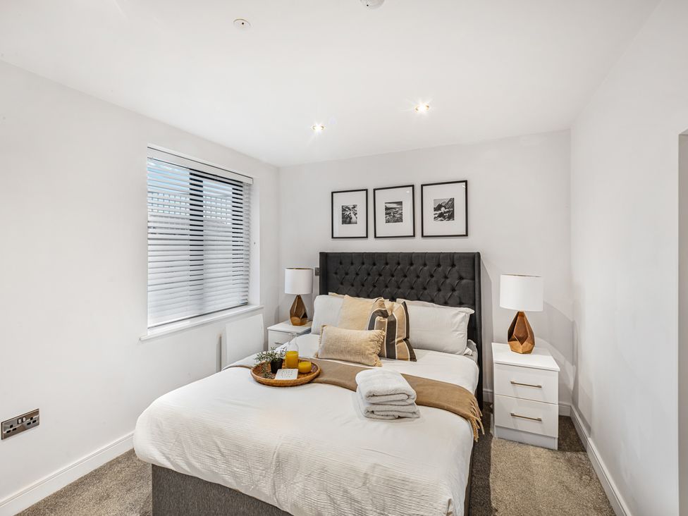 A bedroom with a bed and bedside tables at York Suite in Chester