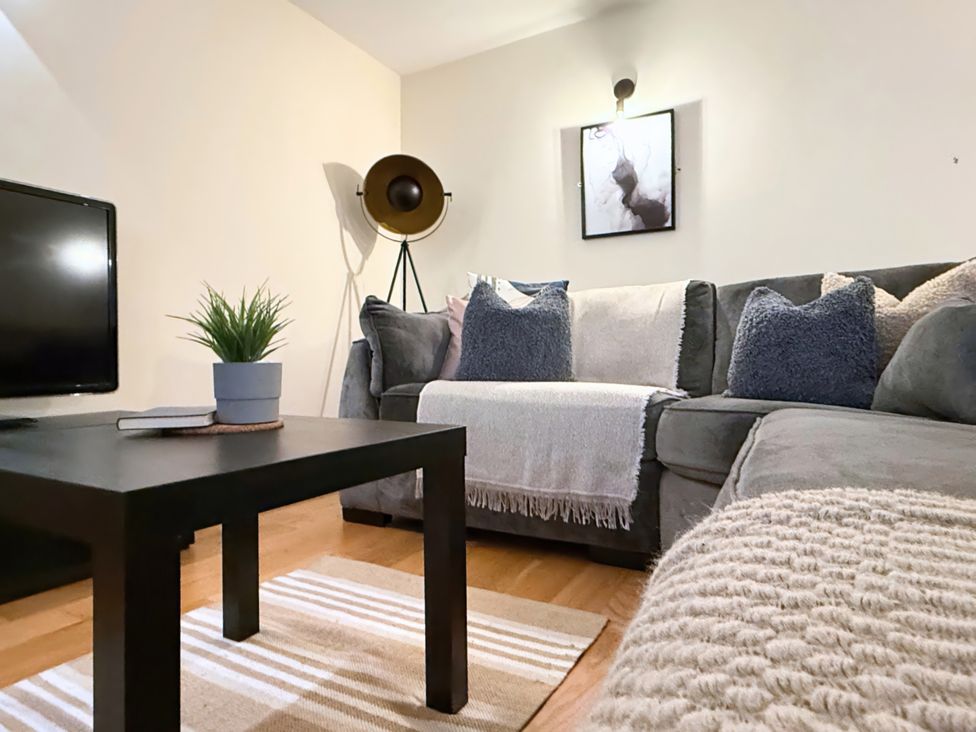 A living room with a sofa and television at The Stables in Troutbeck