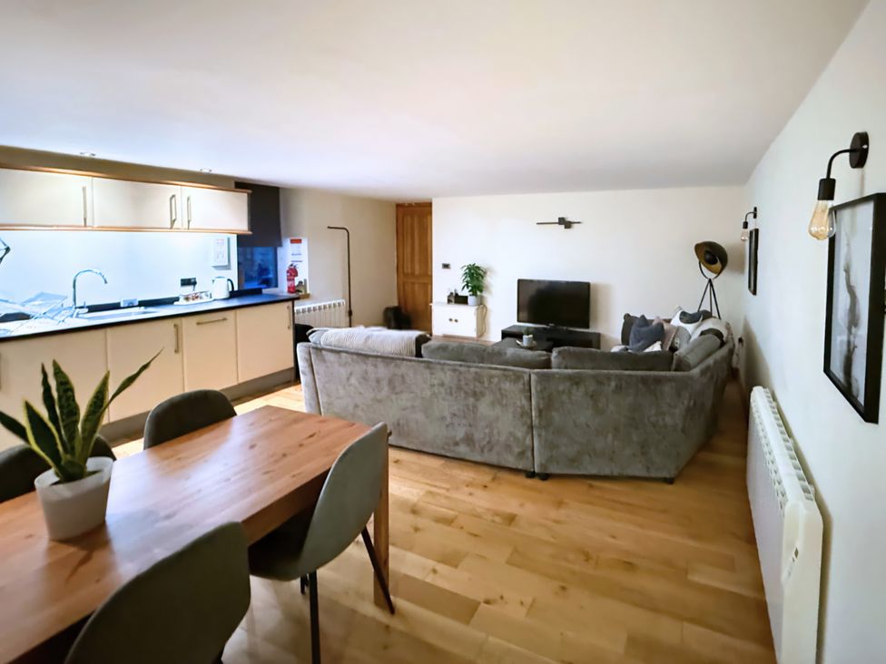 A living room with a sofa and television at The Stables in Troutbeck