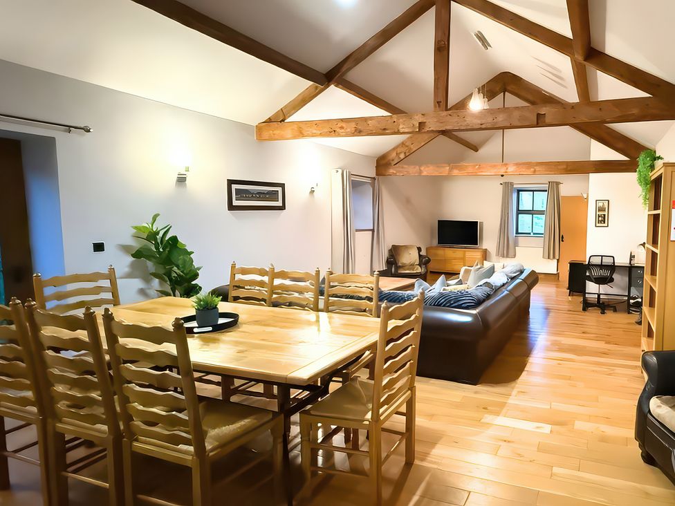 A dining room with a table and chairs at Old Corner Barn in Troutbeck