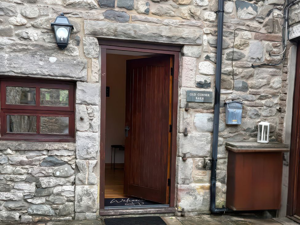 An entryway with a wooden door at Old Corner Barn in Troutbeck