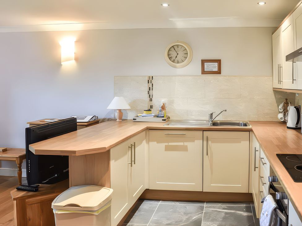 A kitchen with cabinets and a sink at Crag Barn Cottage in Troutbeck