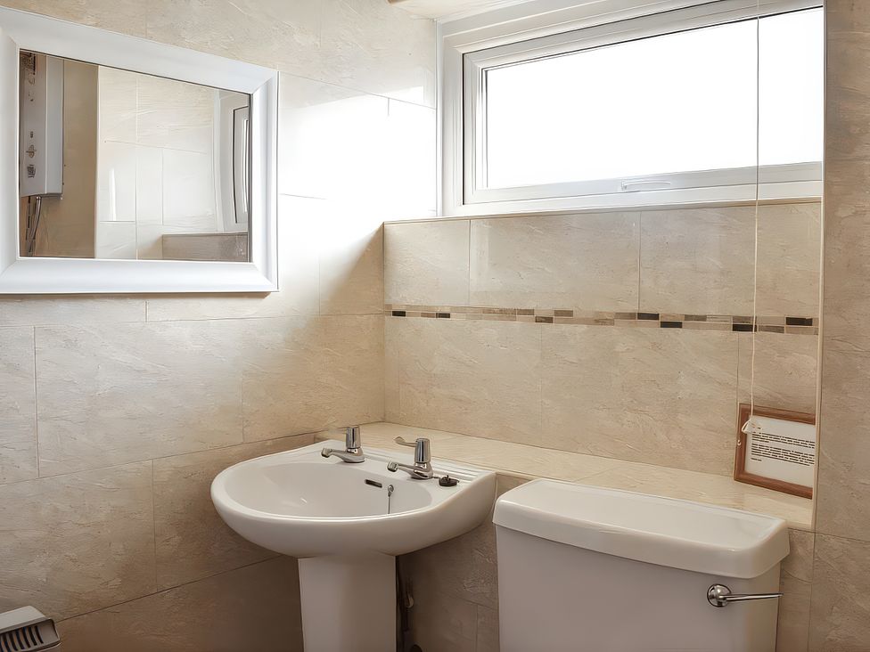 A bathroom with a sink and toilet at Crag Barn Cottage Troutbeck