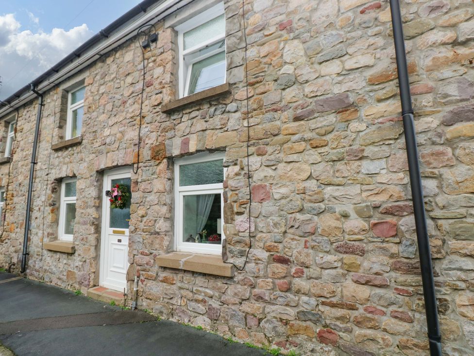 An outdoor view of a stone house at Tawe Cottage in Swansea