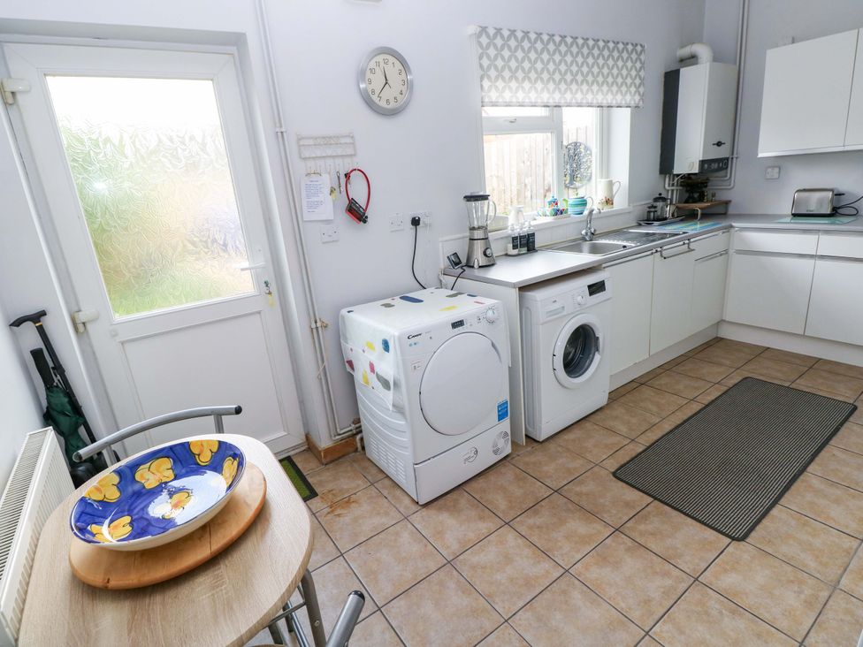 A kitchen with a washing machine and tumble dryer at Tawe Cottage in Swansea
