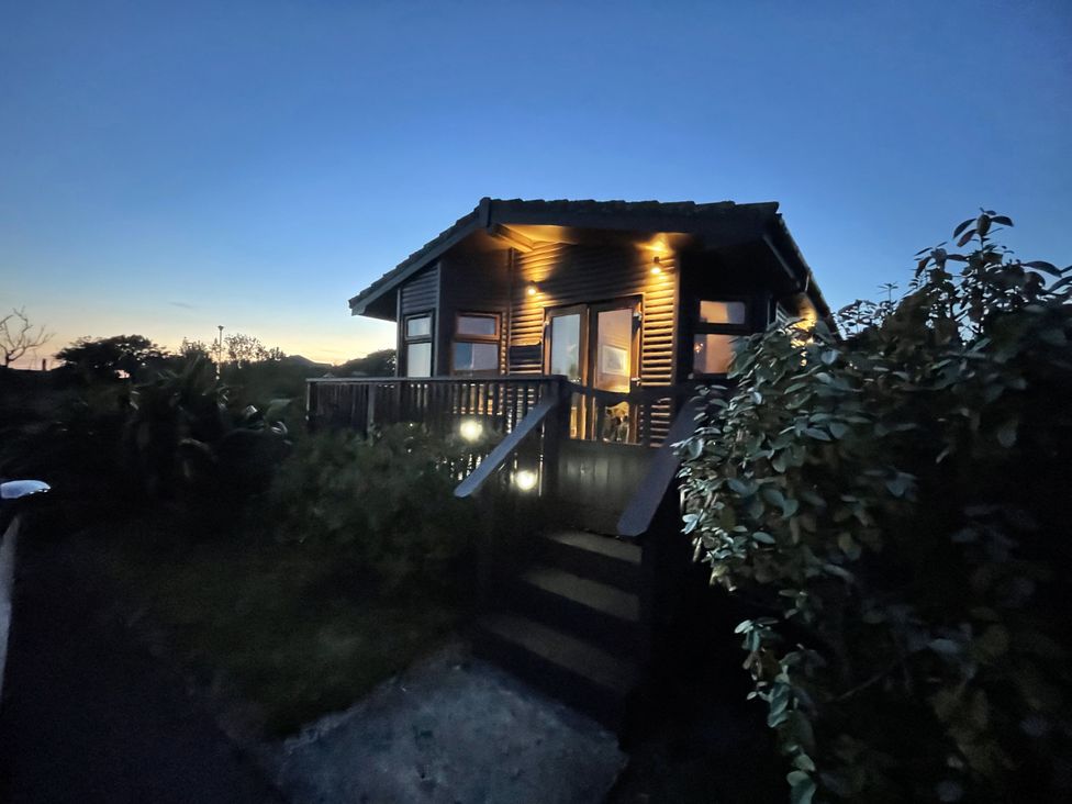 A house with a deck and steps at Lamorna in Sennen