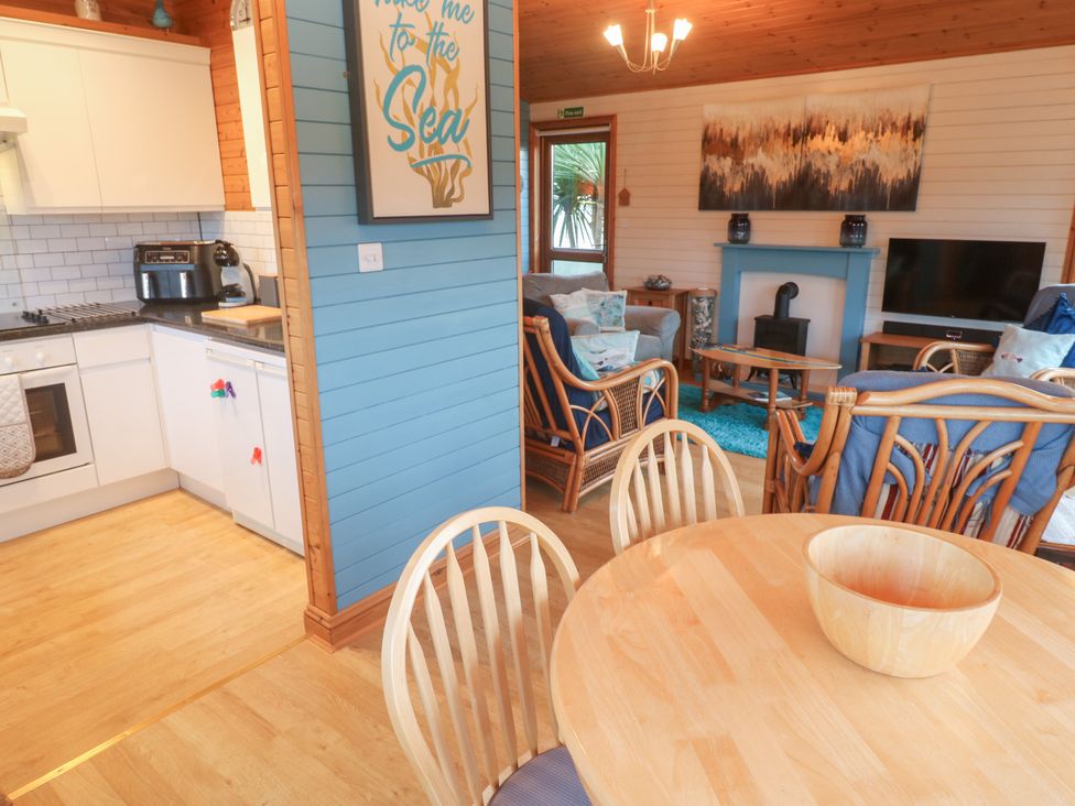 A kitchen and living room with a dining area at Lamorna in Sennen
