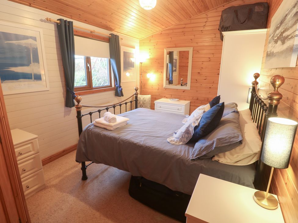 A bedroom with a bed and dresser at Lamorna in Sennen