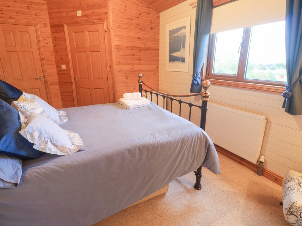 A bedroom with a bed and window at Lamorna Sennen