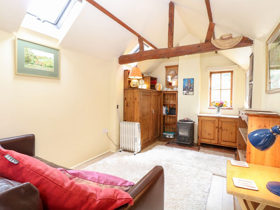 A snug with a sofa and a shelving unit at The Retreat in Norwich