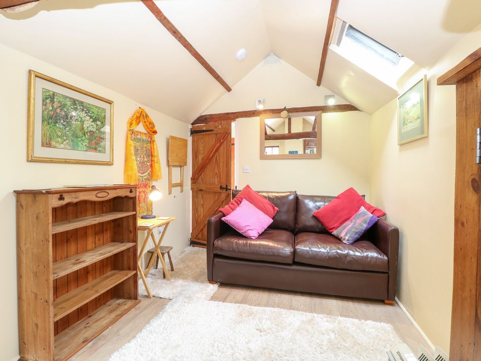 A snug with a sofa and shelf at The Retreat in Norwich