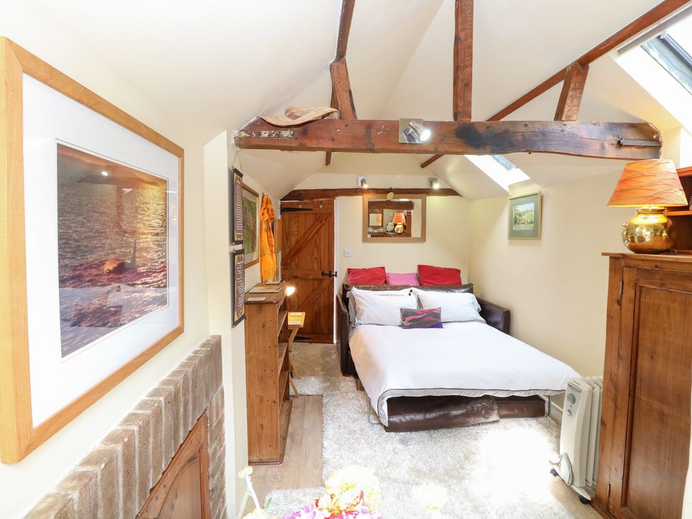 A bedroom with a bed and nightstand at The Retreat in Norwich