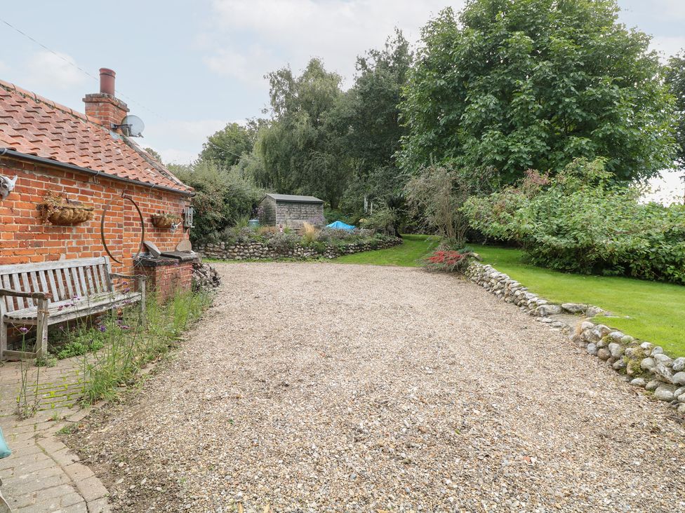 An outdoor space with a bench and gravel area at The Retreat in Norwich
