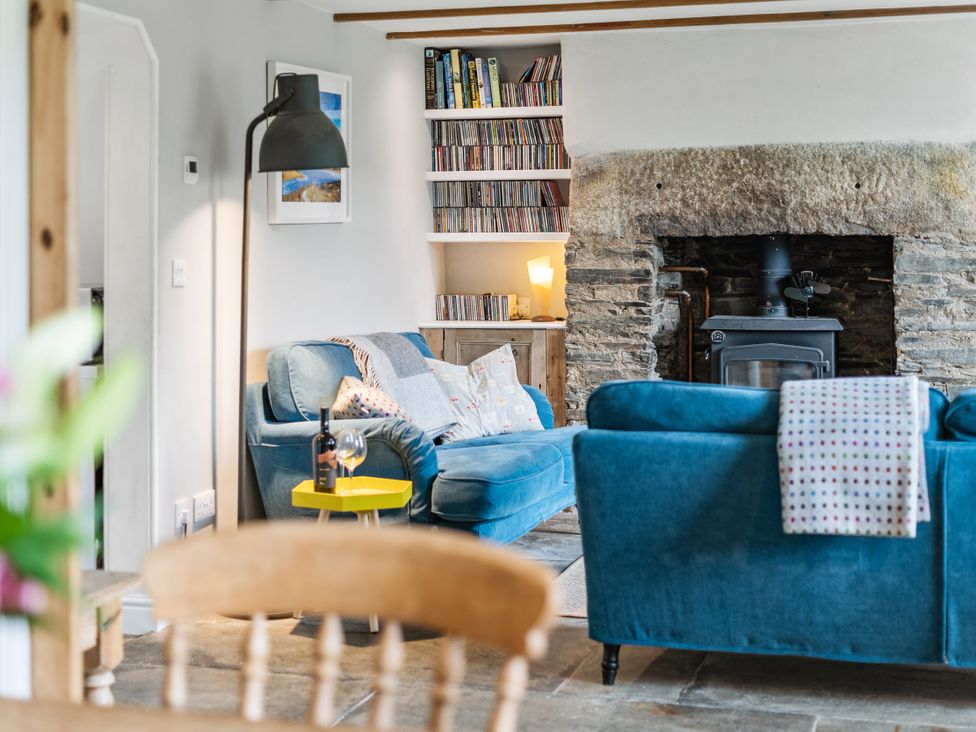 A living room with a sofa and a fireplace at Treovis Cottage in Callington