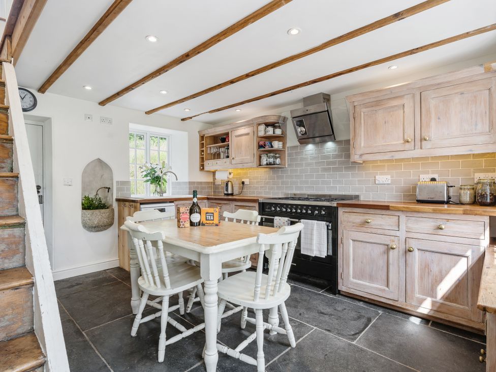 A kitchen with a table and chairs at Treovis Cottage in Callington