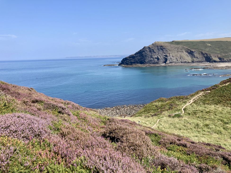 A coastal view with hills and ocean at Treovis Cottage in Callington
