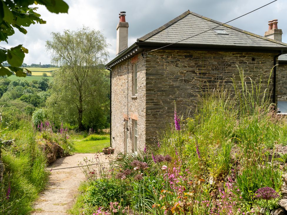 A house with a garden and pathway at Treovis Cottage in Callington